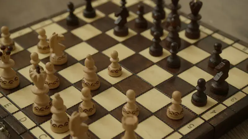 Hand-carved wooden chess pieces mid-game